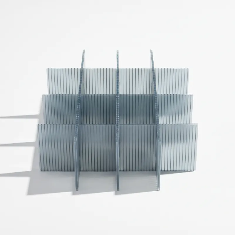 A returnable divider set in translucent grey-blue twin-wall polypropylene, slotted strips interlocking into a grid of cells.